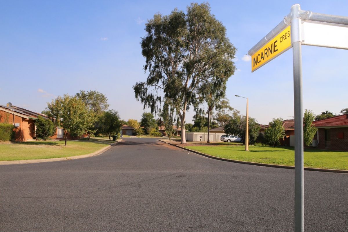 Street sign and road with houses