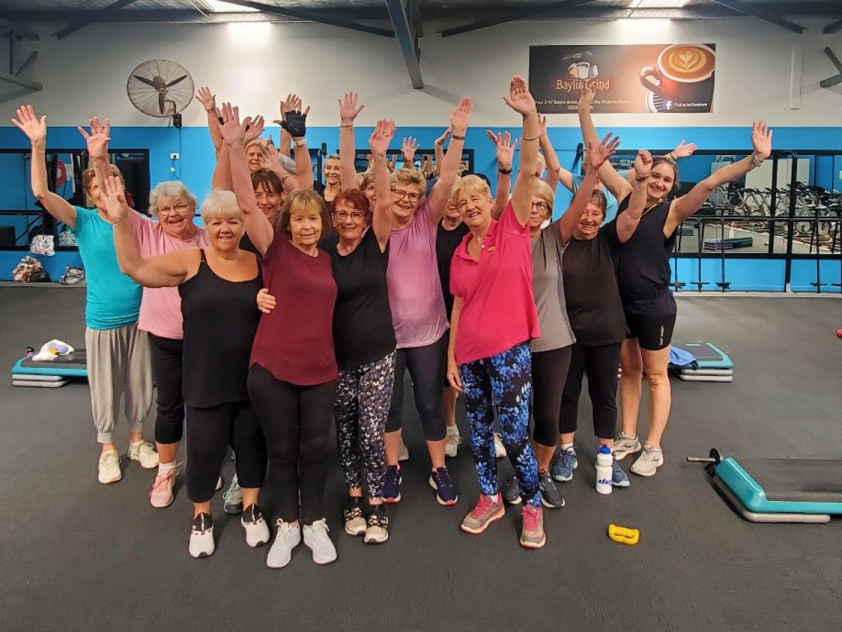 A group of people standing in a gym cheering