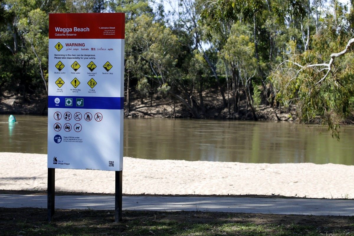 Wagga Beach safety sign in foreground with river in background