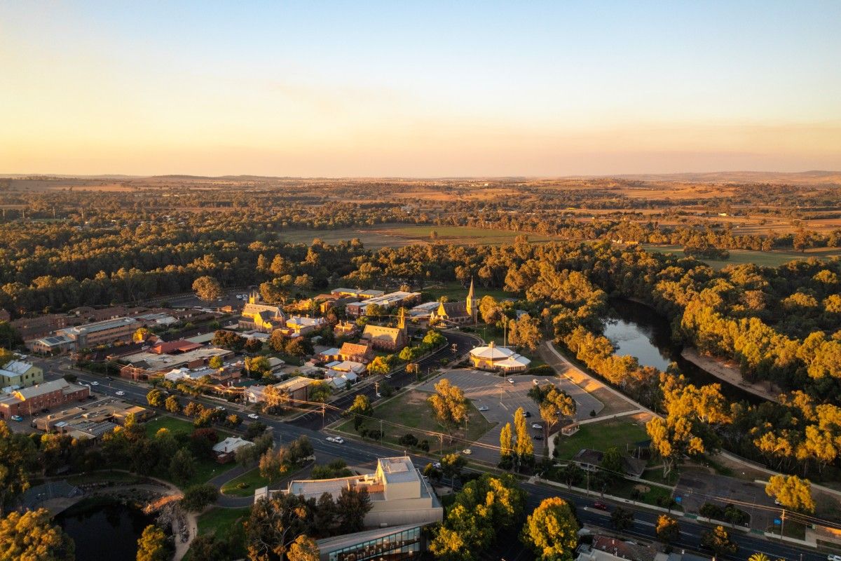 Aerial image of a city centre, with civic building and lagoon in foreground and other business and residential areas in the background.